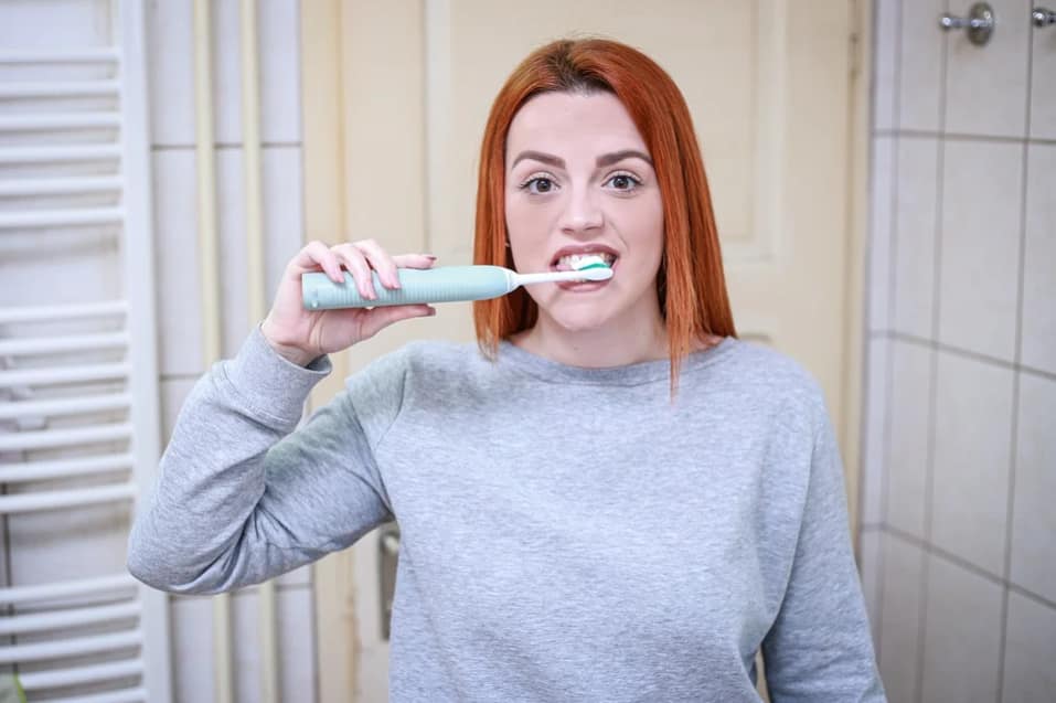 woman brushing teeth